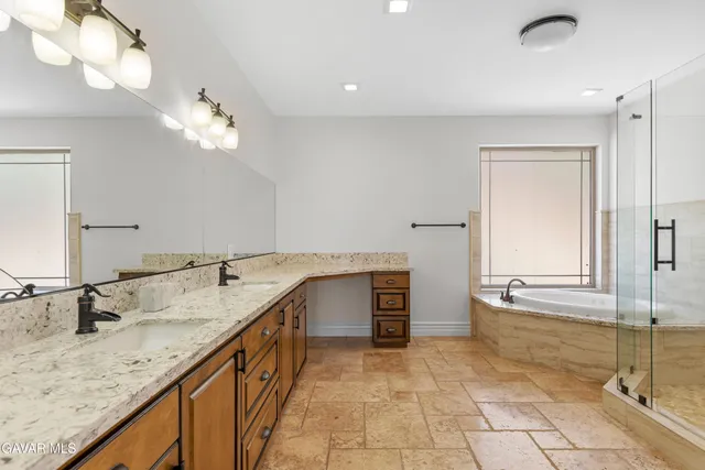 a large white kitchen with granite countertop a stove a sink and a refrigerator