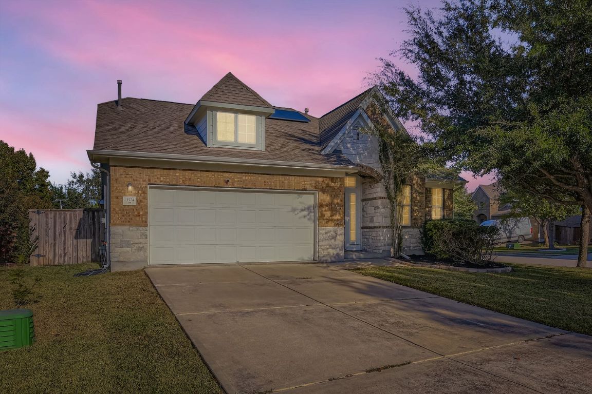 a front view of a house with a yard and garage