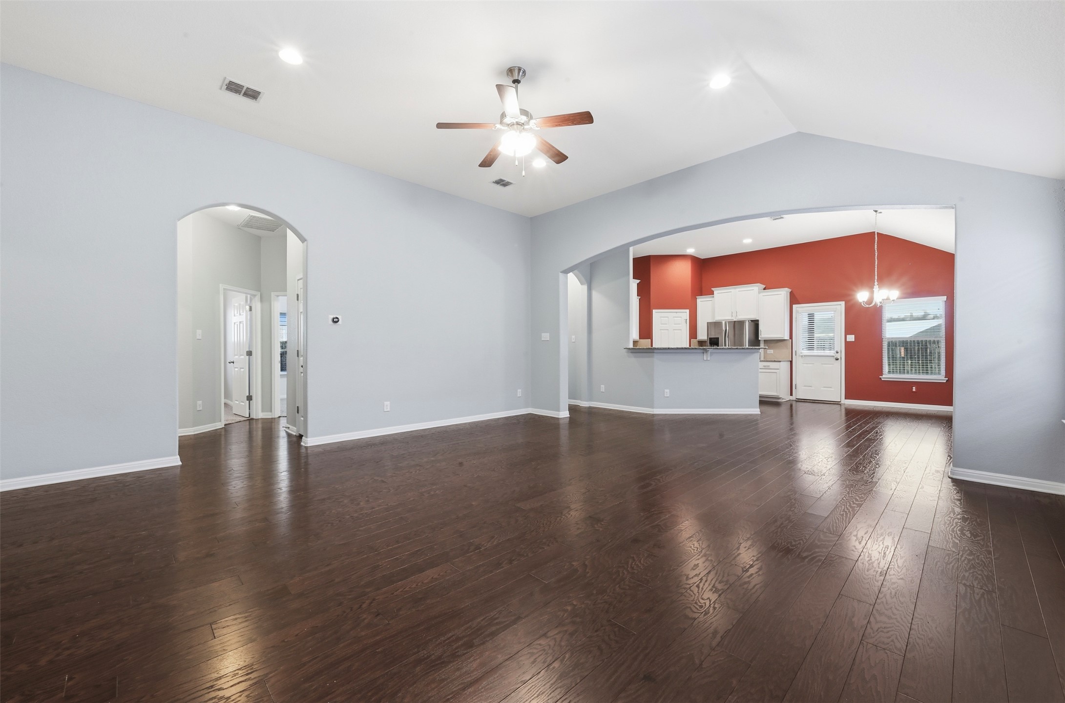 13116 Alans Way Manchaca, TX 78652 - Photo 6 of 25 Spacious living area featuring rich wood-finish flooring, vaulted ceilings, and recessed lighting