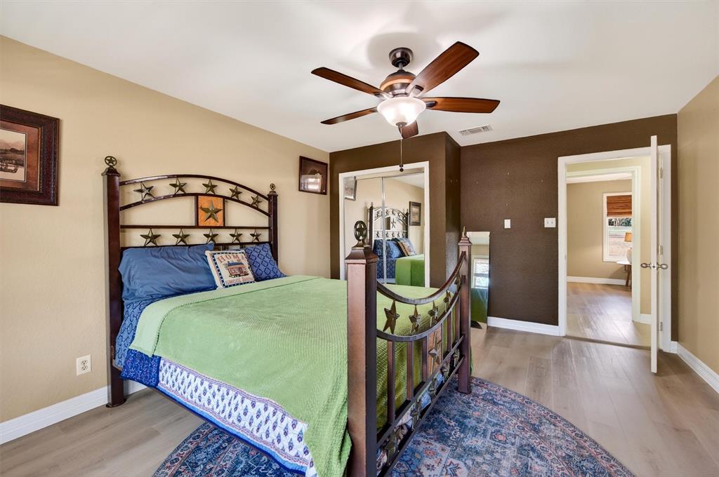 140 Harrell Road Howe, TX 75459 - Photo 29 of 40 a bedroom with a bed and a chandelier