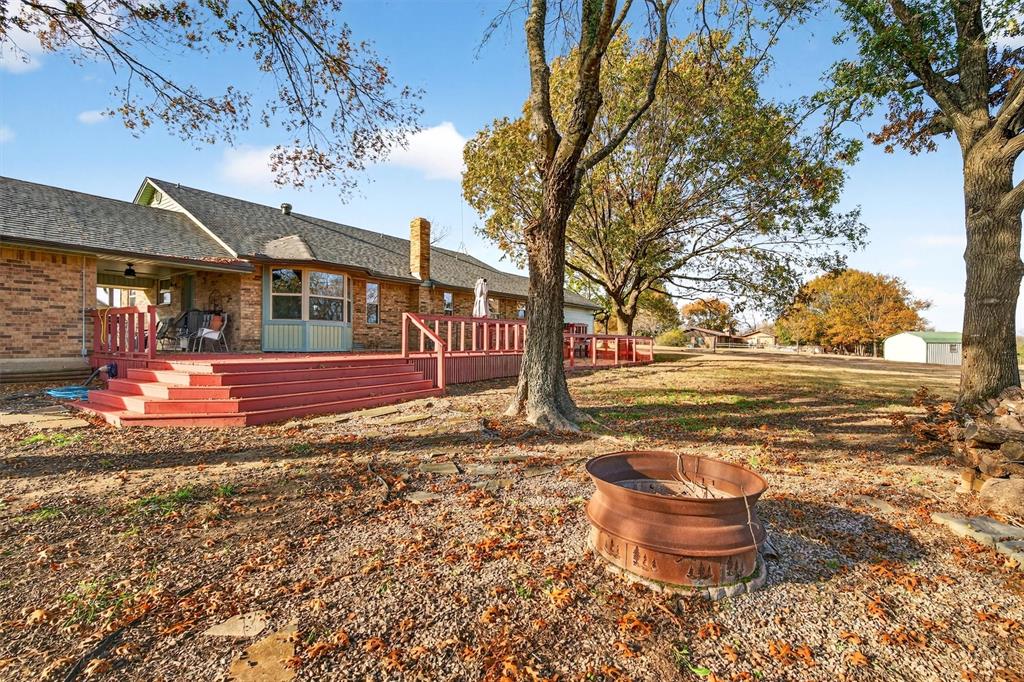 140 Harrell Road Howe, TX 75459 - Photo 35 of 40 a backyard of a house with barbeque oven table and chairs