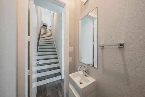 a bathroom with a sink mirror and tub