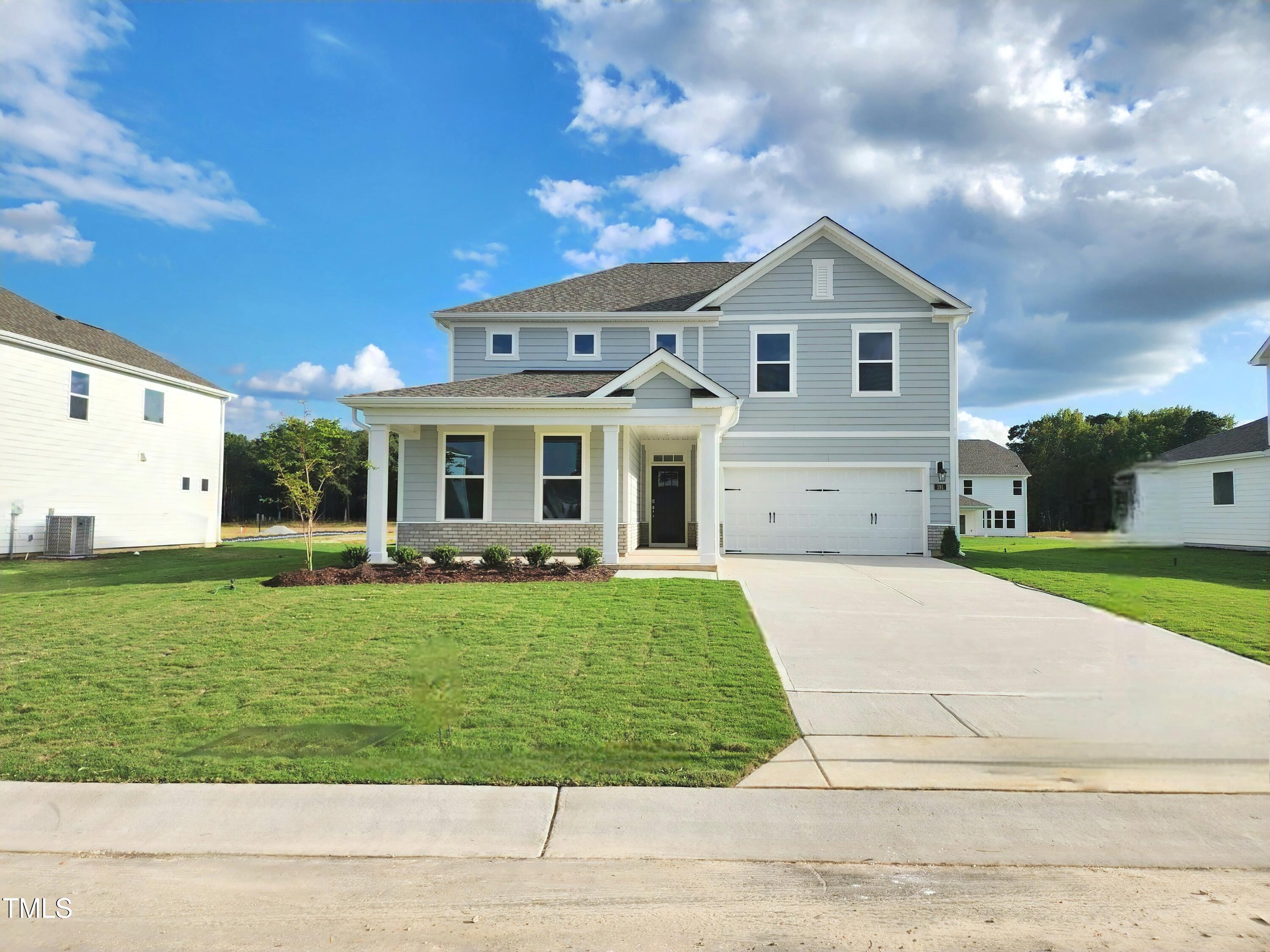 191 Gilmer Street Fuquay-Varina, NC 27526 - Photo 2 of 40 a front view of a house with a yard and garage