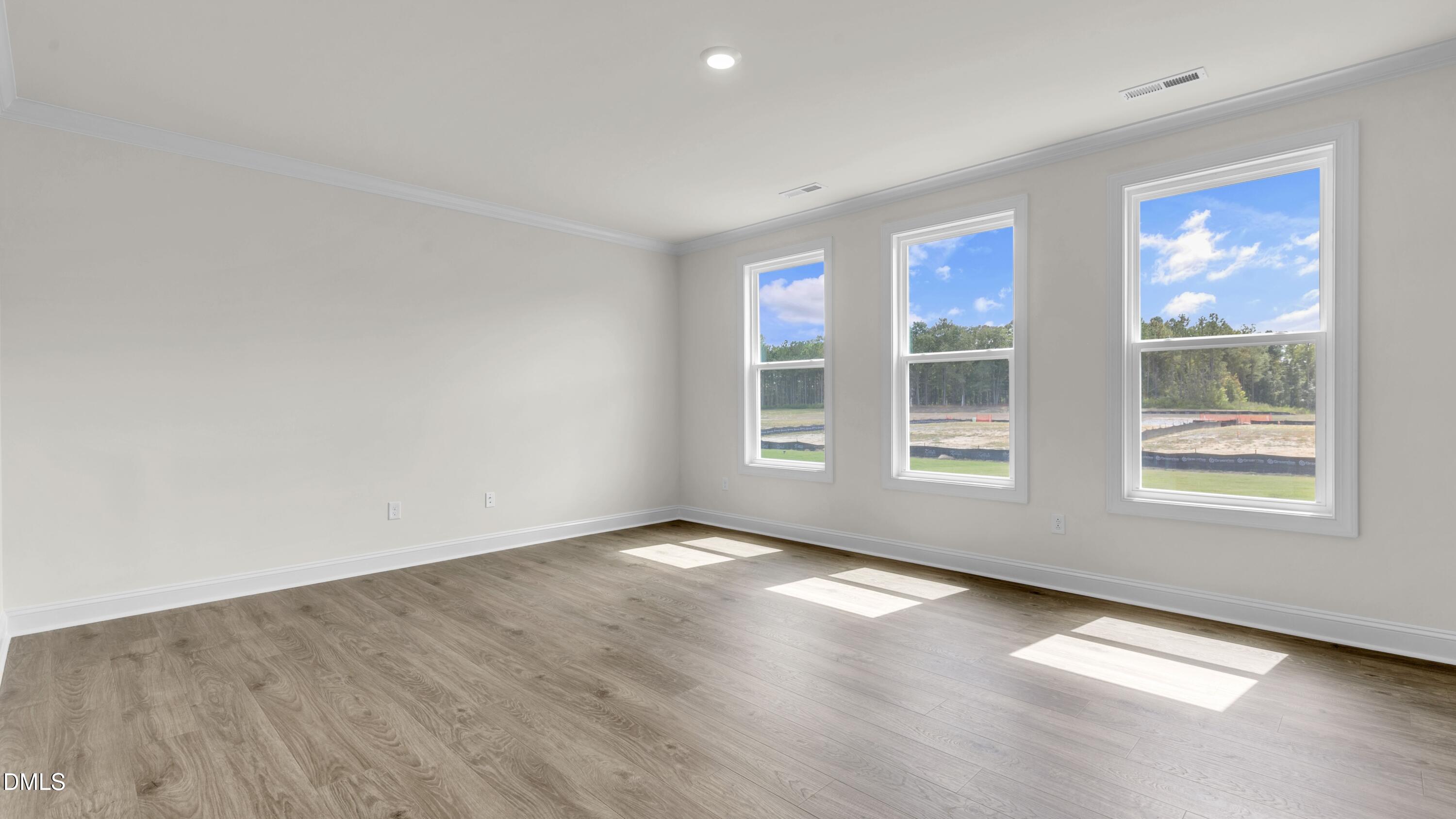 191 Gilmer Street Fuquay-Varina, NC 27526 - Photo 7 of 40 an empty room with windows