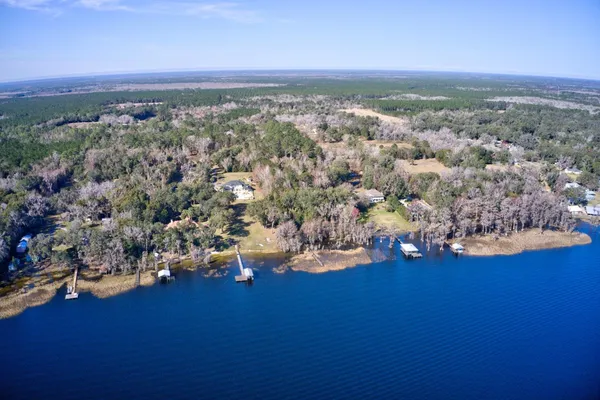 an aerial view of a houses with a yard
