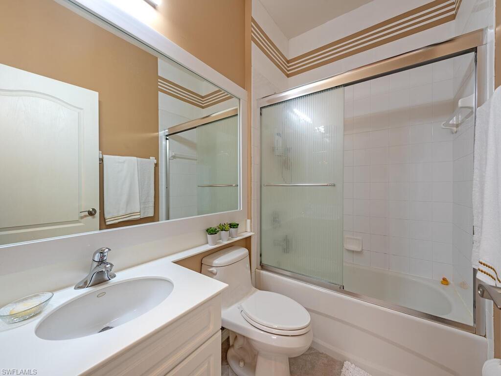 13000 Sandy Key Bend, Unit 3203 North Fort Myers, FL 33903 - Photo 10 of 25 Bathroom with shower / bath combination with glass door and vanity.