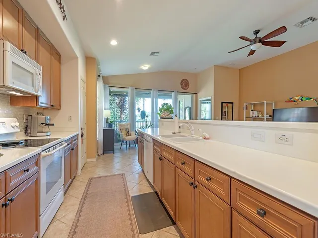 a view of a dining room with furniture and a chandelier