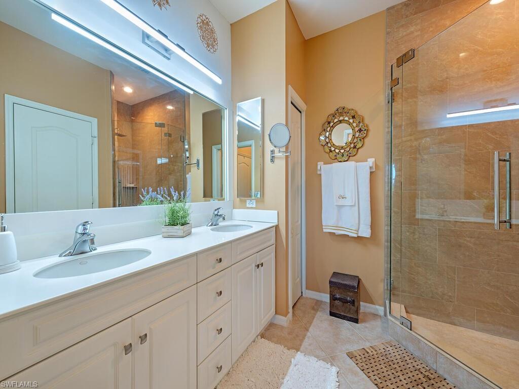 13000 Sandy Key Bend, Unit 3203 North Fort Myers, FL 33903 - Photo 8 of 25 Primary Bathroom with walk-in shower, light tile patterned tile floors, high ceilings and double vanity