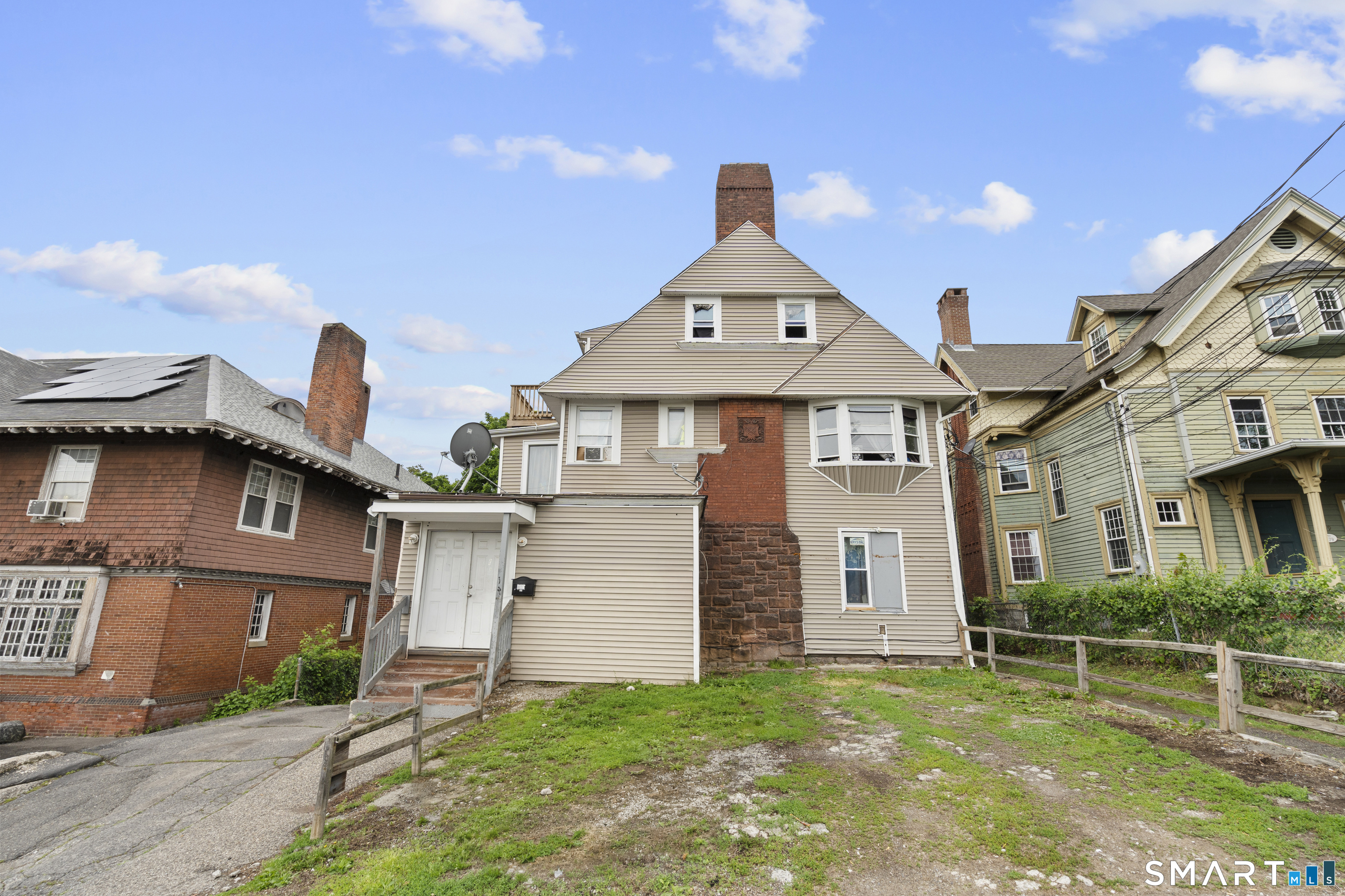 135 Prospect Street Waterbury, CT 06710 - Photo 2 of 19 a front view of a house with a yard