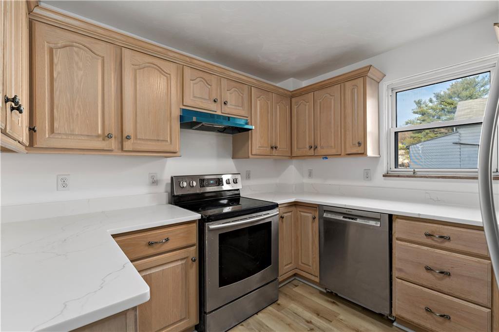 58 Locust Street McKees Rocks, PA 15136 - Photo 13 of 37 a kitchen with granite countertop white cabinets and white appliances