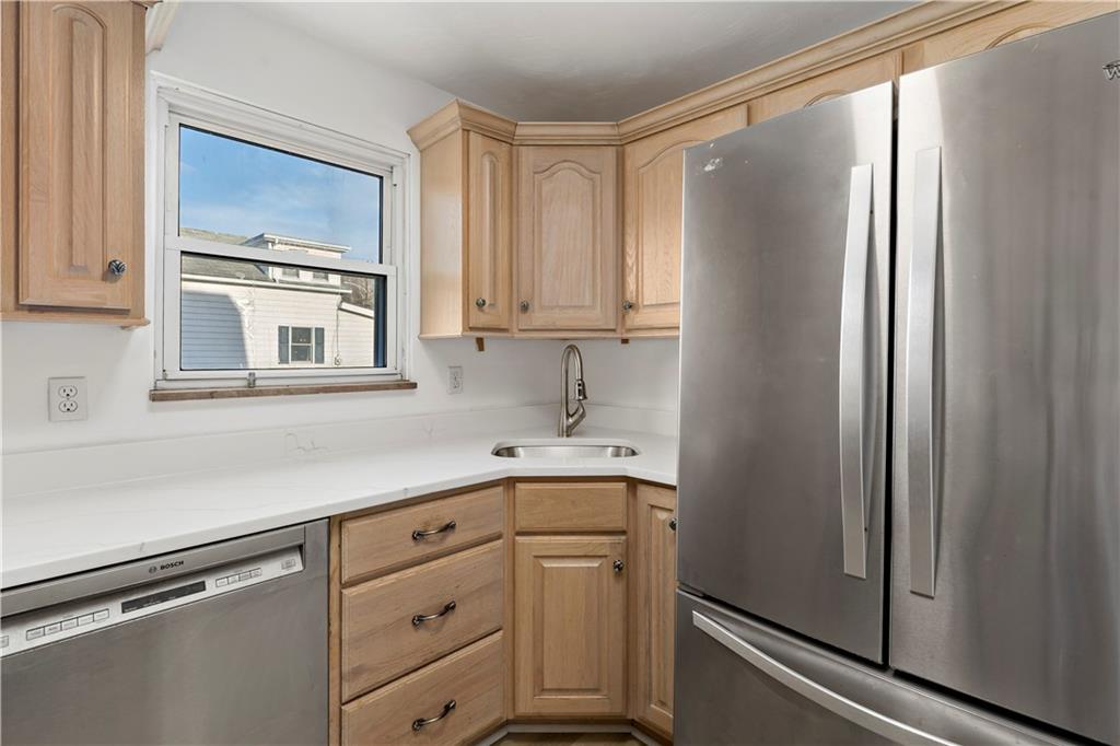 58 Locust Street McKees Rocks, PA 15136 - Photo 14 of 37 a kitchen with cabinets stainless steel appliances and a window