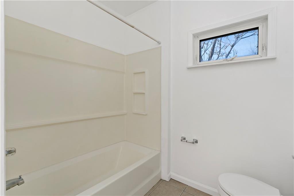 58 Locust Street McKees Rocks, PA 15136 - Photo 26 of 37 a white bath tub sitting next to a toilet
