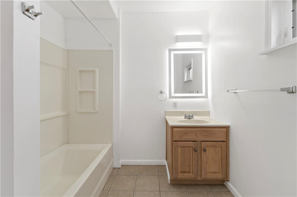 58 Locust Street McKees Rocks, PA 15136 - Photo 28 of 37 a bathroom with a tub sink and mirror