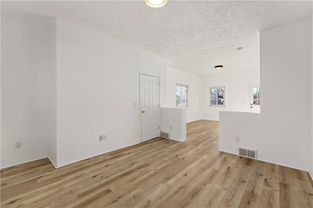 58 Locust Street McKees Rocks, PA 15136 - Photo 7 of 37 an empty room with wooden floor and windows