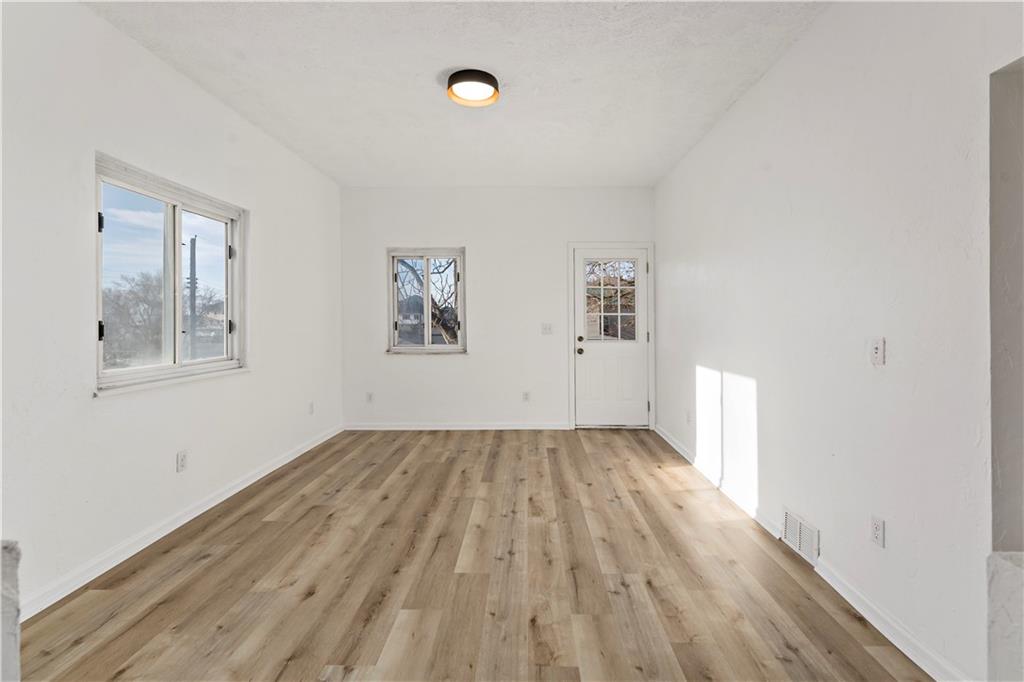 58 Locust Street McKees Rocks, PA 15136 - Photo 10 of 37 an empty room with wooden floor and windows