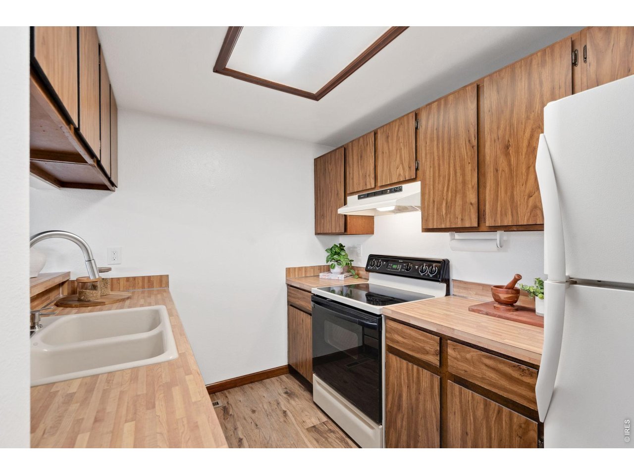 1900 Real Court, Unit A Fort Collins, CO 80526 - Photo 12 of 39 a kitchen with stainless steel appliances granite countertop a sink stove and refrigerator with wooden floor