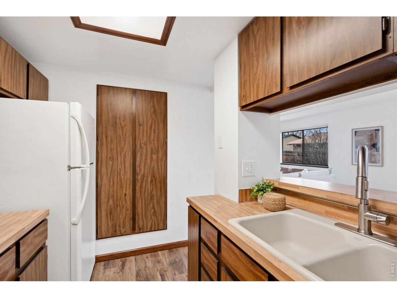 1900 Real Court, Unit A Fort Collins, CO 80526 - Photo 14 of 39 a kitchen with a sink cabinets and a refrigerator