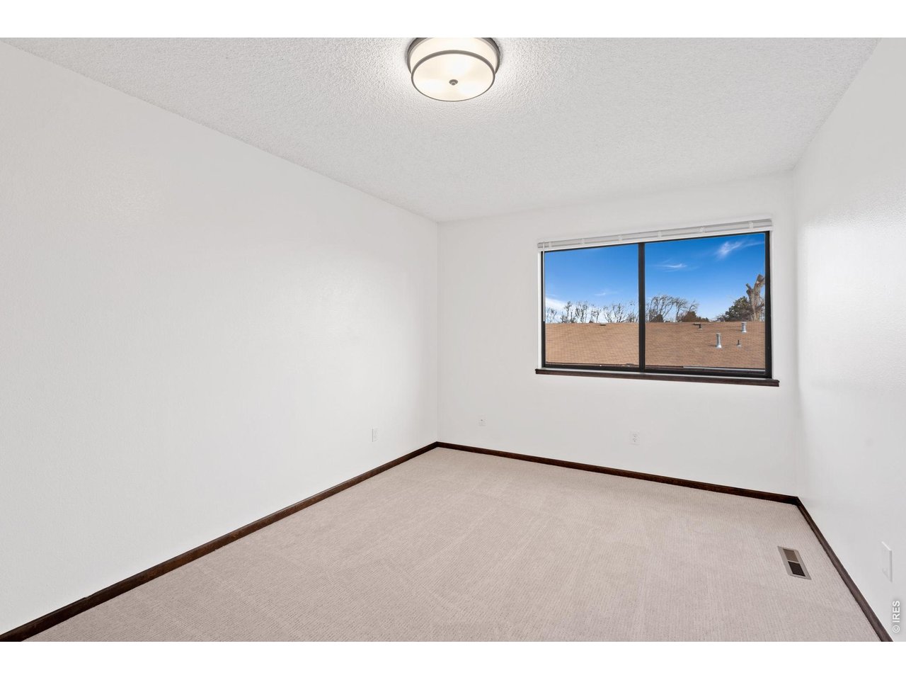 1900 Real Court, Unit A Fort Collins, CO 80526 - Photo 19 of 39 a view of empty room with wooden floor