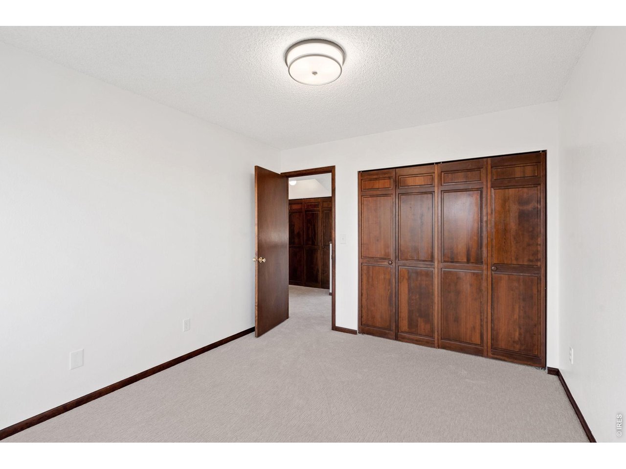1900 Real Court, Unit A Fort Collins, CO 80526 - Photo 20 of 39 a view of a room with wooden floor