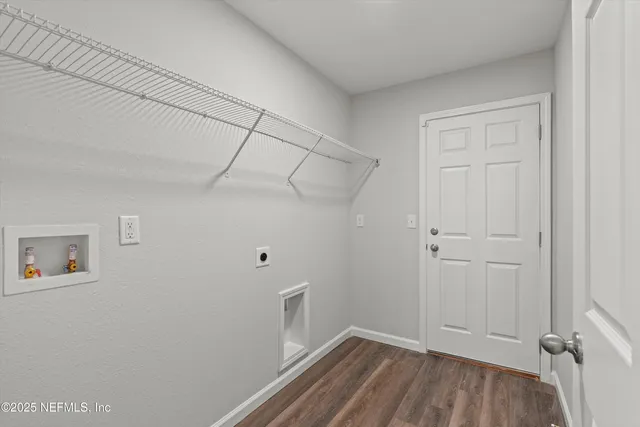 a view of a room with wooden floor