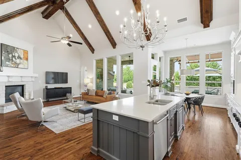 a living room with furniture a fireplace and a table
