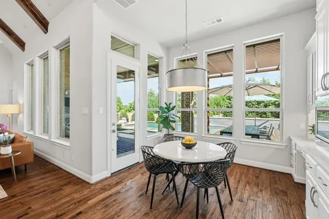 a view of a dining room with furniture window and wooden floor