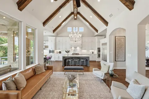 a living room with furniture a fireplace and a large window