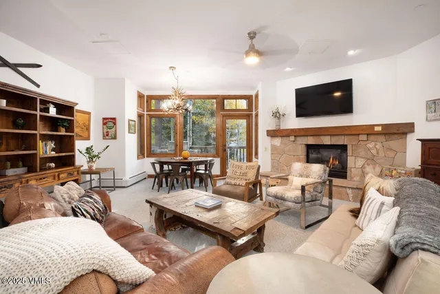 a living room with furniture fireplace and flat screen tv