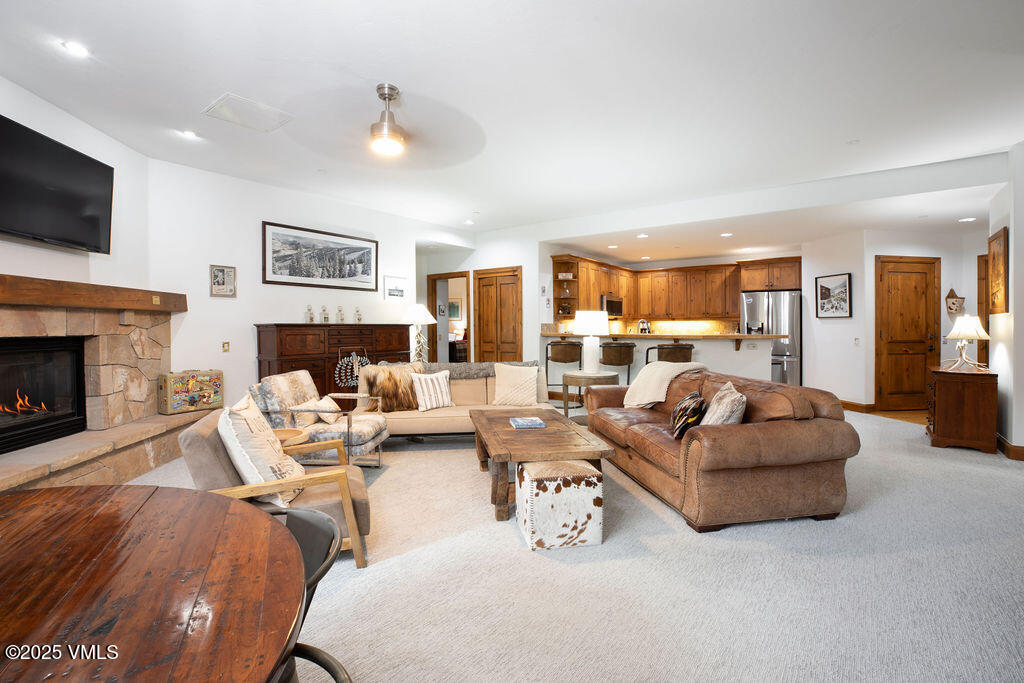 160 Cresta Road, Unit R202 Edwards, CO 81632 - Photo 3 of 25 a living room with furniture fireplace and a flat screen tv