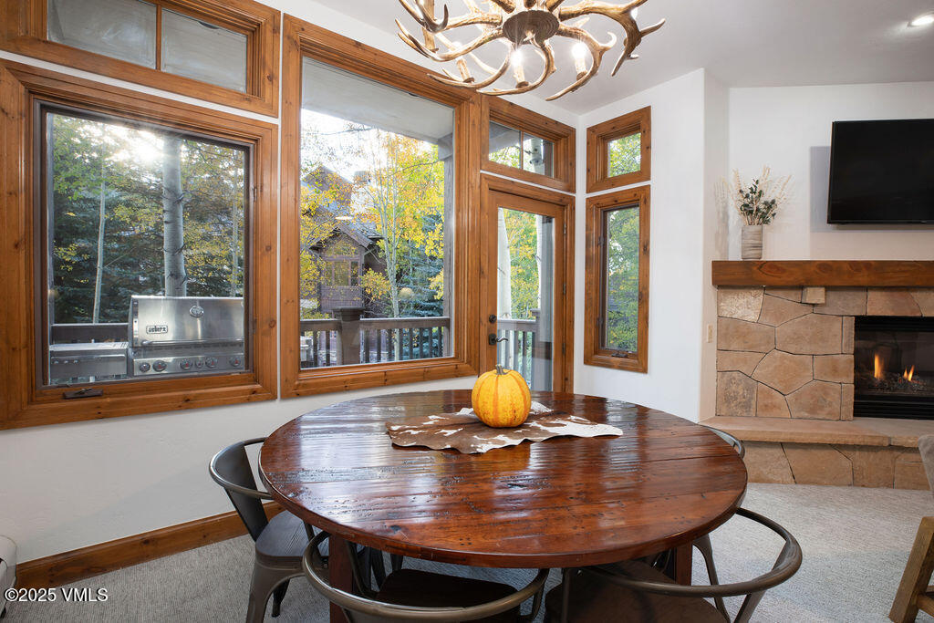 160 Cresta Road, Unit R202 Edwards, CO 81632 - Photo 5 of 25 a view of a dining room with furniture window and wooden floor