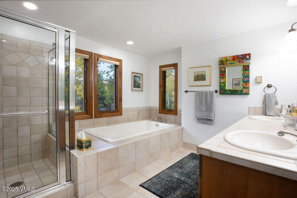 160 Cresta Road, Unit R202 Edwards, CO 81632 - Photo 8 of 25 a spacious bathroom with sink shower and mirror