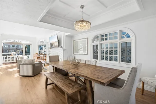 a view of a dining room with furniture wooden floor and a chandelier