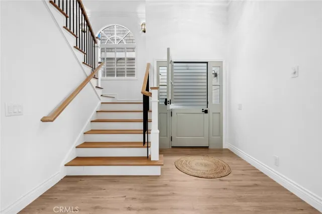a view of entryway with wooden floor and stairs