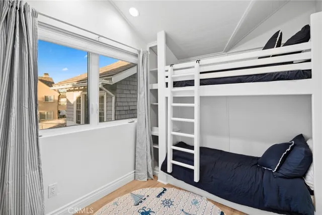 a view of bedroom with furniture and wooden floor