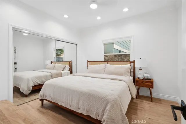 a bedroom with two beds and painting on the wall