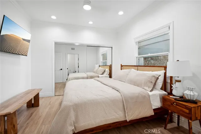 a bedroom with a bed and a night stand