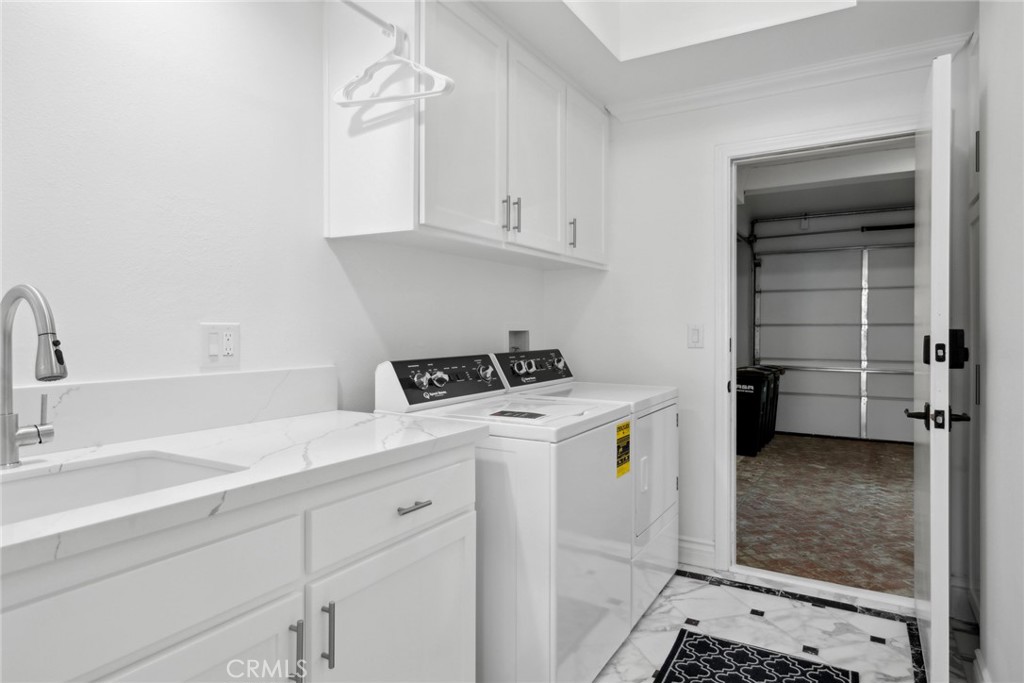 125 Grand Canal Newport Beach, CA 92662 - Photo 33 of 41 a utility room with cabinets washer and dryer