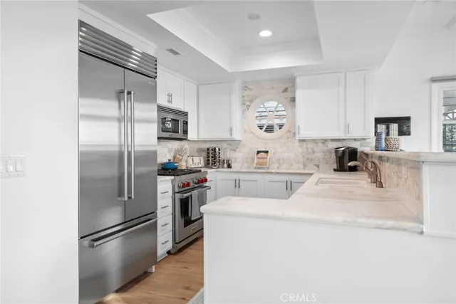 a kitchen with a refrigerator a stove and a sink