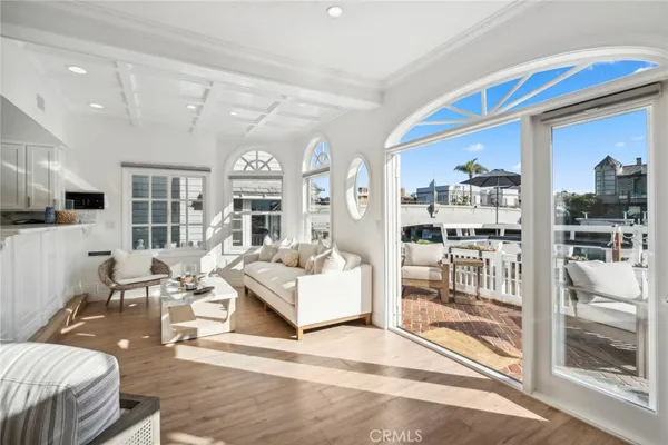 a living room with patio furniture and a large window