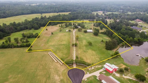 an aerial view of residential houses with outdoor space and swimming pool