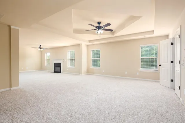 a view of a livingroom with a ceiling fan and window
