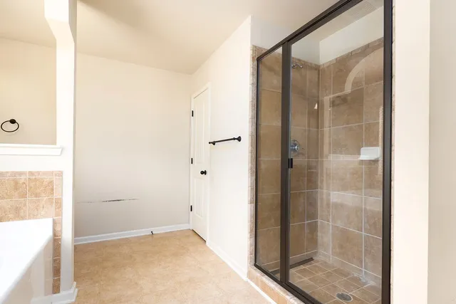 a bathroom with a glass shower door
