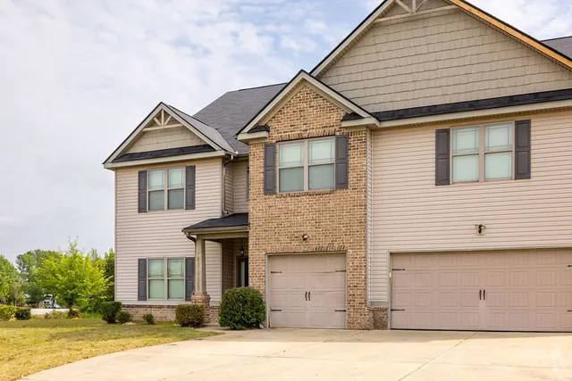 a front view of a house with a garden