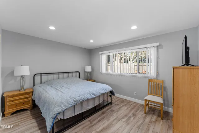 a bed sitting in a bedroom next to a window