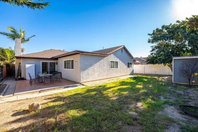 a view of a house with swimming pool and sitting area