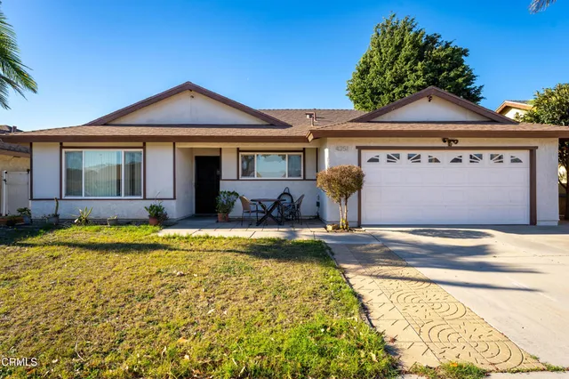 a view of a house with a swimming pool and a yard with plants