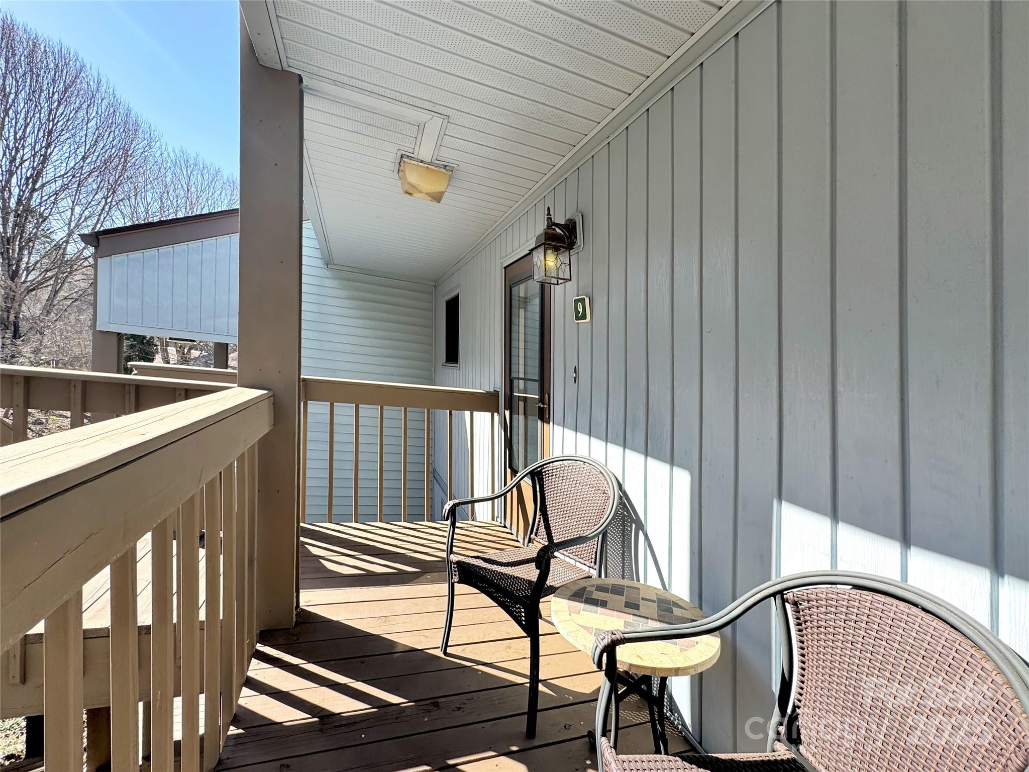 87 Willow Road, Unit C9 Waynesville, NC 28786 - Photo 3 of 31 a view of an chairs and table in the balcony