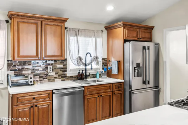 a kitchen with stainless steel appliances granite countertop a refrigerator sink and cabinets