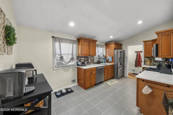 a kitchen with a sink stove and cabinets