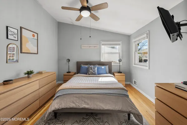 a spacious bedroom with a bed and a chandelier